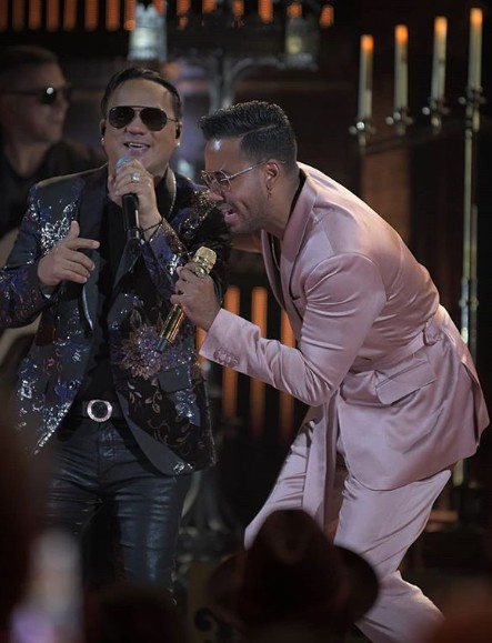 Romeo Santos signs a song with his male co-singer